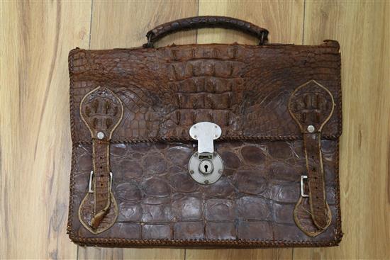 An early 20th century crocodile skin briefcase and a suitcase length 49cm